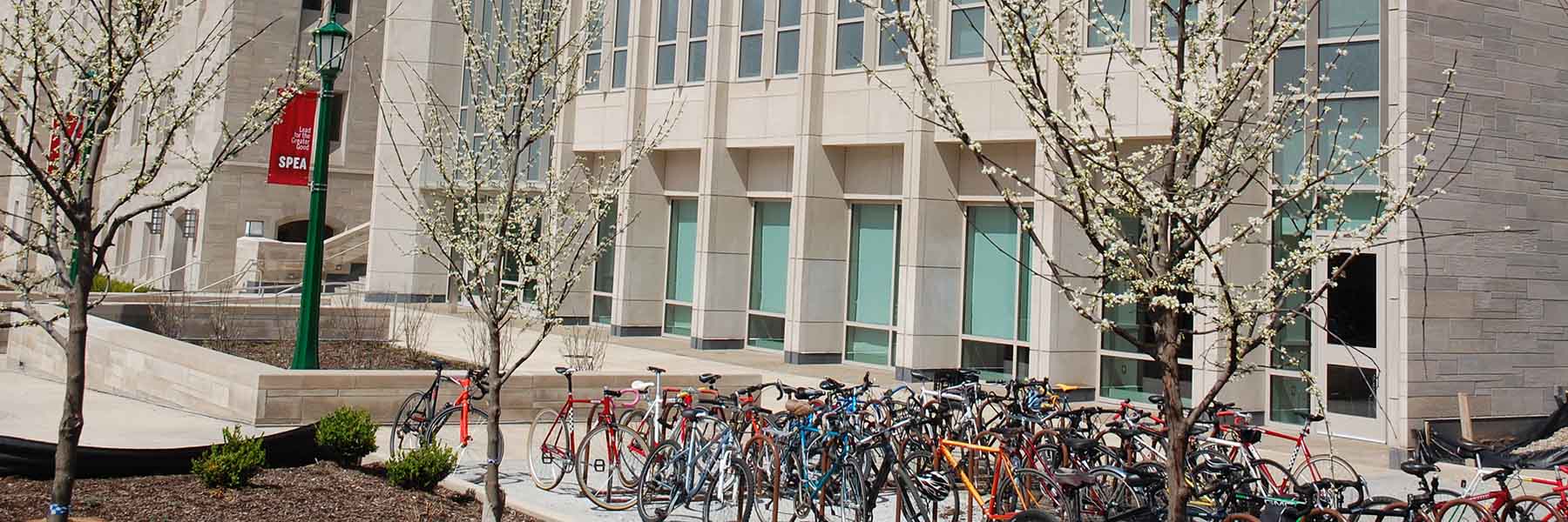 SPEA building in spring with flowering trees and bicycles